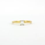 A hallmarked 18ct yellow gold ring set with an emerald cut diamond, (N).