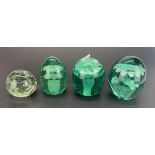 Four early English bottle glass dump paperweights, tallest H. 9cm.