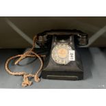 A black Bakelite telephone.