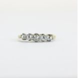 An antique 18ct yellow gold and platinum (worn stamp 18ct) ring set with five graduated old cut