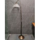 A modern metal standard lamp with glass shade, H. 170cm.