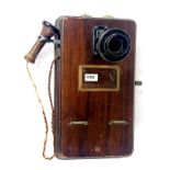 A mahogany wall mounted antique telephone, 50 x 25cm.