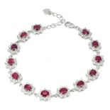 A 925 silver bracelet set with oval cut rubies and white stones, L. 18cm.