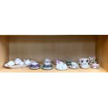 A quantity of miniature cups, saucers and other items.