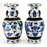 A lovely pair of Chinese hand painted and crackle glazed porcelain vases with lion ring handles,