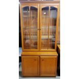 A 1970's teak wood display cabinet, W. 82cm, H. 177cm.