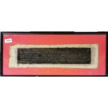 A framed Tibetan sacred scripture, frame size 60 x 27cm.