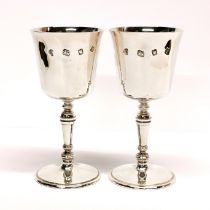 A pair of heavy hallmarked silver goblets, H. 13.5cm with engraved initials.