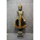 A Thai painted and carved wooden figure of a standing Buddha, H. 113cm (A/F to hands).