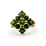 A hallmarked 9ct yellow gold ring set with round and square cut diopside, (M).