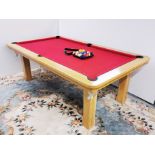A superb light oak slate bed pool table with dining table top cover and balls, 130 x 222 x 78cm.