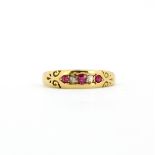 A yellow metal (tested high carat gold) ring set with rubies and diamonds, (N).