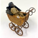 An antique composition and cloth baby doll, with a small reproduction pram.