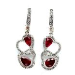 A pair of 925 silver drop earrings set with pear cut rubies and white stones, L. 3.7cm.
