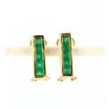 A pair of 18ct yellow gold (stamped 18K) clip back earrings set with square cut emeralds, L. 1.5cm.