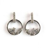 A pair of 9ct white gold diamond set earrings, L. 1.1cm.