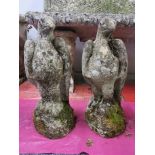 Two antique carved sandstone garden figures of birds with glass eyes, H. 44cm.