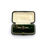 A boxed antique hallmarked 9ct yellow gold (worn hallmark) bar brooch set with a round cut