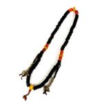 A strand of Tibetan bone prayer beads with prayer counters and faux coral and amber, closed L.