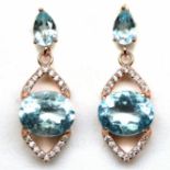 A pair of rose gold on 925 silver drop earrings set with blue topaz and white stones, L. 2.8cm.