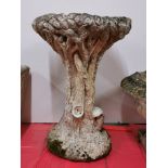 An antique carved sandstone natural form birdbath, H. 66cm, Dia. 47cm.