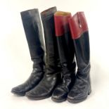 Two pairs of vintage leather riding boots.