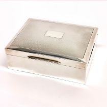 A hallmarked silver covered cigarette box with engine turned decoration, 11.5 x 8.5 x 4cm.