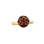 A 9ct gold and silver ring set with round rose cut garnets, (O.5). One stone missing.