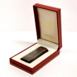 A boxed 'Must de Cartier' cigarette lighter.