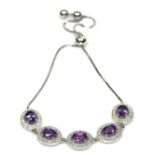 A 925 silver adjustable bracelet set with oval cut amethysts and white stones.