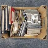 A collection of postcards, small photographs, ephemera and stamps.