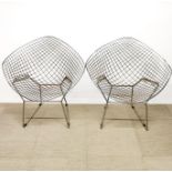 A pair of 'Harry Bertoia' chromium plated metal chairs, W. 84cm.