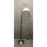 A modern metal standard lamp with glass shade, H. 170cm.
