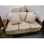 A three piece suite comprising of a three seater carved walnut and cane sofa together with two