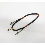 A strand of Tibetan bone prayer beads with prayer counters and faux coral and amber, closed L.