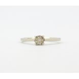 A white metal (tested minimum 9ct gold) diamond set cluster ring, (J).