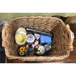 A wicker basket containing a silver handled cake knife and a quantity of Wedgwood and other china.