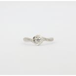 A 9ct white gold (stamped 9k) solitaire ring set with a brilliant cut diamond and diamond set