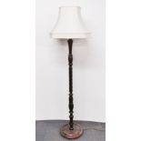 A turned mahogany standard lamp and shade, overall H. 168cm.