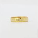 A gent's hallmarked 18ct yellow gold ring set with diamonds, (U.5).