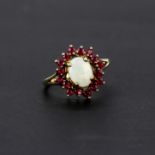 A 9ct yellow gold ring set with opal and rubies, (T).