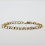 A 925 silver gilt stone set tennis bracelet, L. 19.5cm.