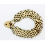 A hallmarked 9ct gold gate bracelet with heart padlock, L. 20cm.