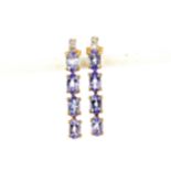 A pair of 9ct yellow gold earrings set with oval cut tanzanite and diamonds, L. 2.5cm.