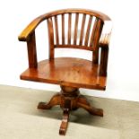 An unusual carved maple swivel chair, W. 60cm.
