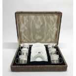 A boxed set of six Wedgwood porcelain coffee cups with hallmarked silver cup holders.