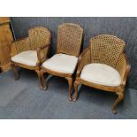 A matching pair of carved walnut and cane armchairs together with a walnut and cane hall chair. Hall