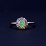 A rose gold on 925 silver ring set with a round cut opal surrounded by white stones, ®.