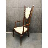 An unusual 19th century upholstered beechwood armchair, H. 127cm.