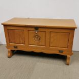 A carved light oak cabinet with drop down front, 112 x 47 x 61cm.